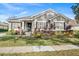 House exterior with gray siding, stone accents, and lush landscaping at 11911 Mandevilla Ct, Tampa, FL 33626