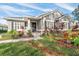 House exterior with gray siding, stone accents, and lush landscaping at 11911 Mandevilla Ct, Tampa, FL 33626