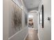 Elegant hallway with hardwood floors and unique wall art at 11911 Mandevilla Ct, Tampa, FL 33626