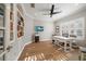 Bright home office features built-in shelving, hardwood floors, and large windows at 11911 Mandevilla Ct, Tampa, FL 33626