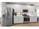 Stainless steel appliances and white cabinetry in this modern kitchen at 11911 Mandevilla Ct, Tampa, FL 33626