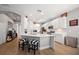 Modern kitchen with white cabinets, quartz countertops, and stainless steel appliances at 11911 Mandevilla Ct, Tampa, FL 33626
