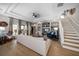 Bright living room with hardwood floors, built-in shelving, and access to the backyard at 11911 Mandevilla Ct, Tampa, FL 33626