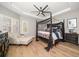 Elegant main bedroom with a canopy bed and hardwood floors at 11911 Mandevilla Ct, Tampa, FL 33626