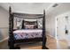 Main bedroom with a four-poster bed and access to en-suite bathroom at 11911 Mandevilla Ct, Tampa, FL 33626
