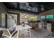 Outdoor kitchen with grill and stone finishes at 11911 Mandevilla Ct, Tampa, FL 33626