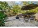 Relaxing patio with seating area, umbrella, and beautiful tile at 11911 Mandevilla Ct, Tampa, FL 33626