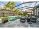 Screened pool and patio area with lounge chairs at 11911 Mandevilla Ct, Tampa, FL 33626