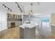 Modern kitchen with white quartz countertops, stainless steel appliances, and blue glass tile backsplash at 1350 Gulf Blvd, Clearwater, FL 33767