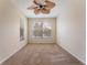 Bright bedroom with ceiling fan and large windows at 14215 Waterville Cir, Tampa, FL 33626