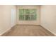 Empty bedroom with large window and carpet at 14215 Waterville Cir, Tampa, FL 33626