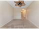 Spacious bedroom with ceiling fan and arched hallway at 14215 Waterville Cir, Tampa, FL 33626