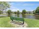 Tranquil lakefront community with bench and fountain at 14215 Waterville Cir, Tampa, FL 33626