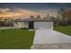 Single-story house with a garage and a well-maintained lawn at 14467 Hawk Rd, Brooksville, FL 34614