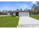 Newly built single-story home with a grassy lawn at 14467 Hawk Rd, Brooksville, FL 34614