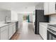 Open concept kitchen with island and view into living area at 14467 Hawk Rd, Brooksville, FL 34614