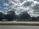Ranch-style home with a spacious yard, located on a busy road at 17048 State Road 54, Lutz, FL 33558