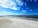 Stunning panoramic view of a pristine beach under a vibrant blue sky at 18650 Gulf Blvd # 413, Indian Shores, FL 33785