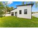 Modern home with backyard, grassy lawn, and privacy fence at 1905 W Erna Dr, Tampa, FL 33603