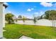 Landscaped backyard with lush green grass and a privacy fence at 1905 W Erna Dr, Tampa, FL 33603