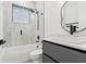 Modern bathroom with gray vanity and walk-in shower at 1905 W Erna Dr, Tampa, FL 33603