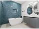 Bathroom with herringbone tile and a free-standing tub at 1905 W Erna Dr, Tampa, FL 33603
