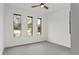 Bright bedroom with ceiling fan and three windows at 1905 W Erna Dr, Tampa, FL 33603