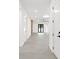 Bright hallway with gray tile floors and white walls, leading to living area at 1905 W Erna Dr, Tampa, FL 33603
