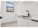 Clean laundry room with modern sink and cabinets at 1905 W Erna Dr, Tampa, FL 33603