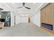 Spacious living area featuring a fireplace and ceiling fan at 1905 W Erna Dr, Tampa, FL 33603