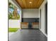 Outdoor kitchen with stainless steel appliances and wood accents at 1905 W Erna Dr, Tampa, FL 33603