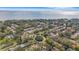 Aerial view of home with water access and lush landscape at 192 Wickford E St, Safety Harbor, FL 34695