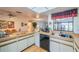 Kitchen features ample counter space and black appliances at 1972 Wolf Laurel Dr, Sun City Center, FL 33573