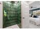 Spa-like shower with green tile and modern fixtures at 2000 80Th N St, St Petersburg, FL 33710