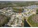 Aerial view of house in a residential neighborhood near a lake at 25237 Lexington Oaks Blvd, Wesley Chapel, FL 33544