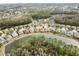 Aerial view of house on a lake in a residential neighborhood at 25237 Lexington Oaks Blvd, Wesley Chapel, FL 33544