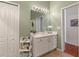 Bathroom with a vanity, white cabinets, and a view into another room at 25237 Lexington Oaks Blvd, Wesley Chapel, FL 33544