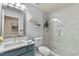 Modern bathroom with a walk-in shower and teal vanity at 25237 Lexington Oaks Blvd, Wesley Chapel, FL 33544