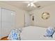 Guest bedroom with double doors to closet and ceiling fan at 25237 Lexington Oaks Blvd, Wesley Chapel, FL 33544