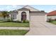 Beautiful one-story home with a two-car garage and well-manicured lawn at 25237 Lexington Oaks Blvd, Wesley Chapel, FL 33544