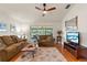 Relaxing living room with hardwood floors, comfortable seating, and sliding glass doors to patio at 25237 Lexington Oaks Blvd, Wesley Chapel, FL 33544