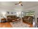 Bright living room with hardwood floors, comfy seating, and access to a relaxing patio at 25237 Lexington Oaks Blvd, Wesley Chapel, FL 33544