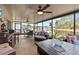 Large screened porch with comfortable seating and multiple seating areas at 25237 Lexington Oaks Blvd, Wesley Chapel, FL 33544