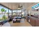 Spacious screened porch with seating area, wet bar, and TV at 25237 Lexington Oaks Blvd, Wesley Chapel, FL 33544