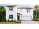 Two-story house with a two-car garage and landscaping at 2883 Gardiner Ln, Zephyrhills, FL 33541