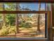 View of backyard through window; lush lawn, trees, and neighboring homes at 300 S Florida Ave # 400D, Tarpon Springs, FL 34689