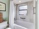 Updated bathroom with a shower/tub, window, and modern fixtures at 300 S Florida Ave # 400D, Tarpon Springs, FL 34689