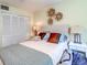 Serene bedroom with queen bed, neutral tones, and windowed closet at 300 S Florida Ave # 400D, Tarpon Springs, FL 34689