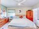 King-size bed in a well-lit bedroom with garden views at 300 S Florida Ave # 400D, Tarpon Springs, FL 34689