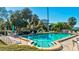 Refreshing community pool with patio furniture and lush foliage at 300 S Florida Ave # 400D, Tarpon Springs, FL 34689